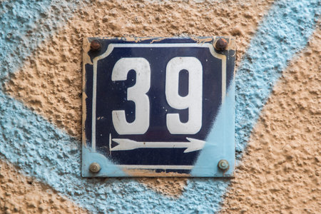 Weathered grunge square metal enameled plate of number of street address with number 39の写真素材