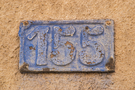 Old retro weathered cast iron plate with number 155の写真素材