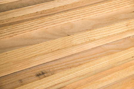 A stacked pile of wooden slats closeup as wooden backgroundの写真素材