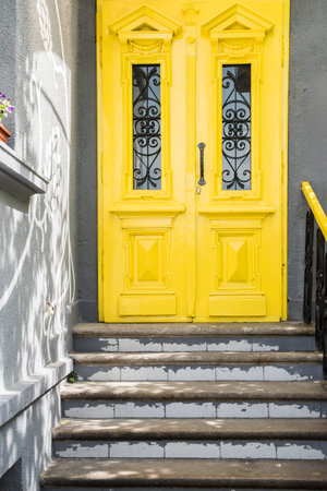 Yellow vintage house door and staircase closeupの写真素材