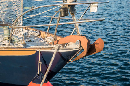Yacht prow with rigging closeup on blue waters background