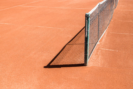 Red clay court surface closeup in tennis complexの写真素材