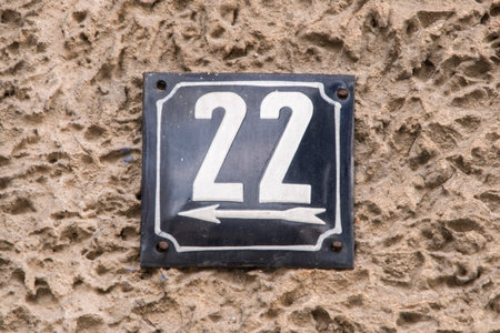 Weathered grunge square metal enameled plate of number of street address with number 22の写真素材