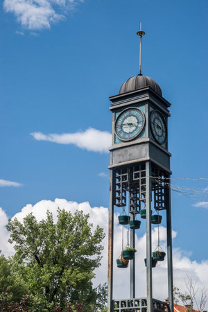 Old clock tower with blue sky and clouds in the background, verticalの写真素材