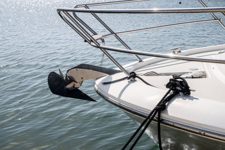 Sailing boat bow with mantus anchor on sea waters backgroundの写真素材