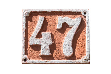 Old retro weathered cast iron plate with number 47 isolated on white backgroundの写真素材