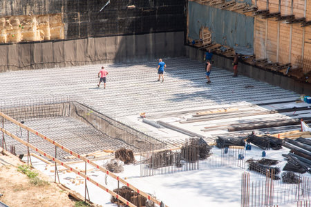 Construction site. Workers are working on the foundation of the building.の写真素材