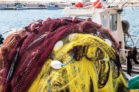 Pile of yellow fishing net in fishing boat closeupの写真素材