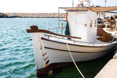 Old vintage fishing boat in Mediterranean port on sunny summer day
