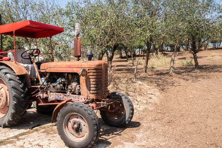 Old weathered grunge vintage tractor on a rural village farm on sunny summer dayの写真素材