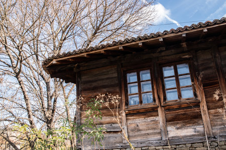 Old wooden rural village country house in autumn time