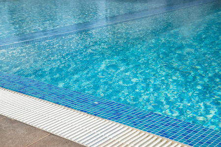 Swimming pool with clear blue water in a luxury hotel resort.の写真素材