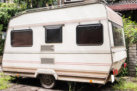 Vintage caravan trailer parked on the street of the city suburb