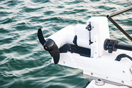 Modern small boat equipped with a bow-mounted electric trolling motor for quiet propulsionの写真素材