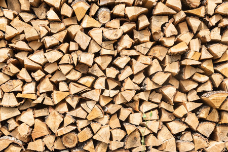 Pile of chopped firewood prepared for winter. Natural background.
