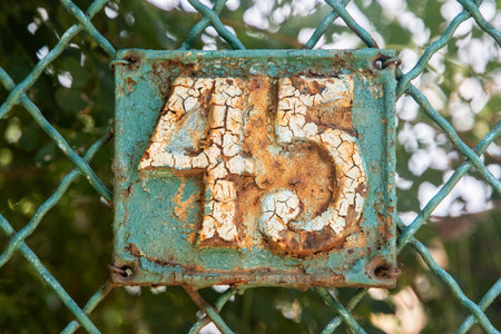 Old retro weathered cast iron plate with number 45