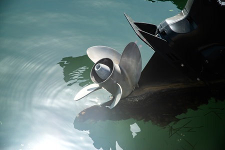 Close up of the propeller of a boat on the water.
