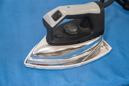 Iron on blue background. Ironing tool. Ironing and ironingの写真素材