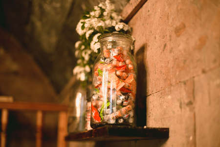 Big glass bottle full of sweets and candiesの写真素材