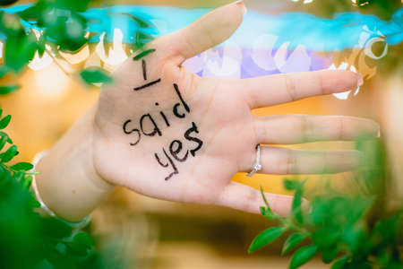 Just engaged girl showing her hand written that she said yesの写真素材