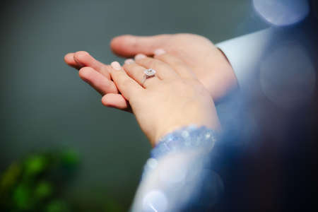 Just engaged couple holding hands. Outdoor photoshoot of lovely couple holding handsの写真素材