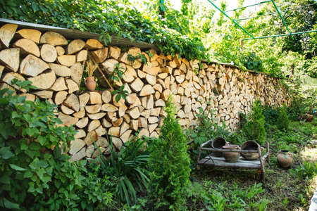 Outdoor timber and clay vase decoration in garden in springの写真素材
