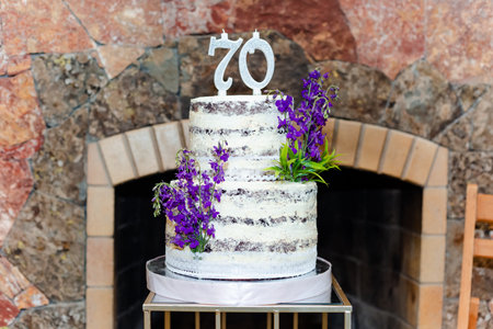 The birthday cake for a 70-year-old man or woman decorated with lavender flowersの写真素材