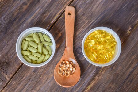 Various dietary supplements on wooden background. Healthy, organic.の写真素材