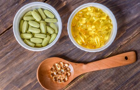 Various dietary supplements on wooden background. Healthy, organic.の写真素材