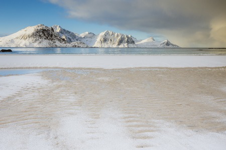 Arctic Beach in the Lofoten Islands in Norway, very beautiful white empty beach with beautiful scenery and mountains in the background and bright skyの写真素材