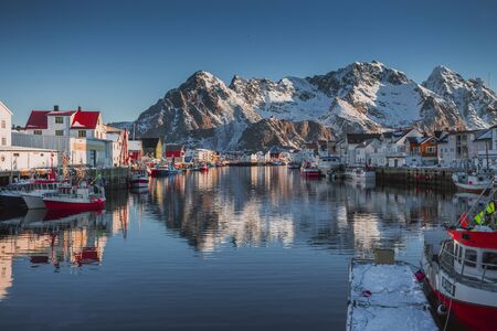 A beautiful small fishing town with a sea bay and a pier for fishing boats on the Lofoten Islands in Norwayの写真素材