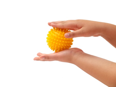 Massage ball in the hand of a little girlの写真素材
