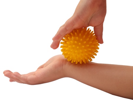 Massage ball in the hand of a little girlの写真素材