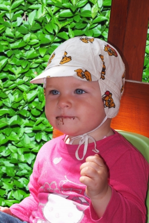 Baby is messed with chocolate on her faceの写真素材