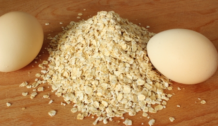 Fresh egg and oatmeal on the tableの写真素材