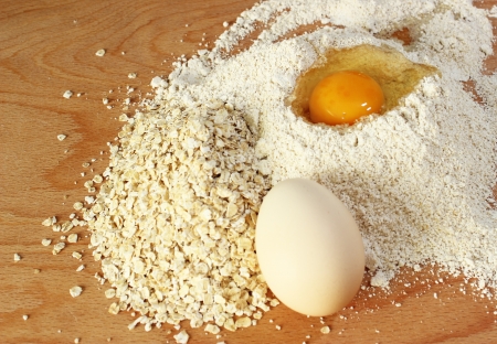 Fresh egg and oatmeal on the tableの写真素材