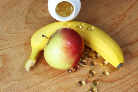 Vitamins in comparison with banana and apple の写真素材