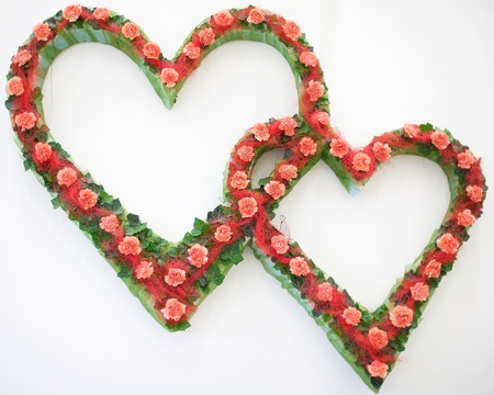 Haert of flowers on a white wallの写真素材