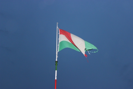 Waving Hungarian Flag Against Blue Skyの写真素材