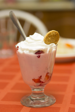 Sweet pudding with whipped cream on the tableの写真素材