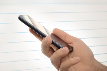 Close up of male hand holding a smart phone    