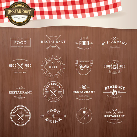 Set of vintage style elements for labels and badges for restaurants, with wood texture and elements of restaurant inventory in the backgroundのイラスト素材