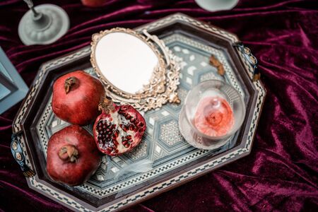 Wedding decorated table with red garnet. Festive table setting. Wedding decor. Table setting in fine art style. Table decor. Catering wedding ceremony, selective and soft focus, seriesの写真素材