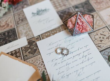 Rustic Wedding invitation card, wax seal, vase, sea stone, flowers. Wedding calligraphy vintage top viewの写真素材
