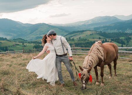 wedding couple. Beautiful bride and groom dancing. Just merried. Close up. Happy bride and groom on their wedding day. Groom and Bride in mountain landscape. wedding dress.の写真素材