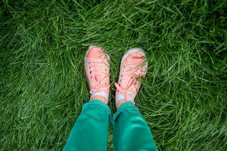 female legs in keds and jeans. Stylish color feet, legsの写真素材
