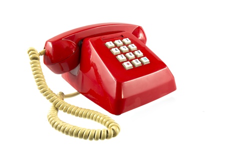 Old red telephone isolated on whiteの写真素材