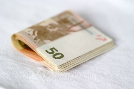 A bundle of 50 Euro notes held together with a paper clip