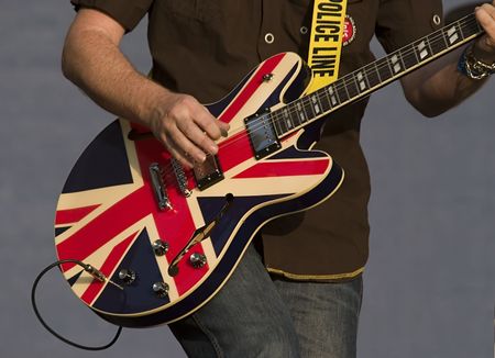 British flag colored guitar being played live on stageの写真素材