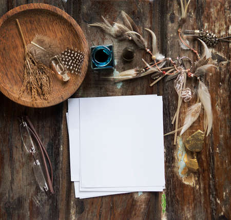 Rustic wooden background with boho chic style decorations: dreamctcher, cup of cappuccino, notebook and paper stars. Copy space for text. Natural, rustic, ethnic or hipster vintage mock up. Top view.の写真素材